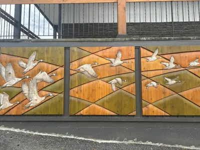 a mural on a wall with birds flying at Chalet Inn in Kitimat