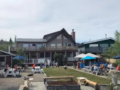 a group of people sitting in a yard in front of a building at Aurora Bayside Inn in Yellowknife