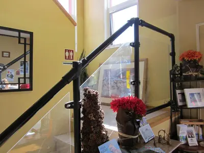 a stair case with a cake and flowers on a table at Aurora Bayside Inn in Yellowknife