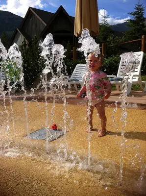 a young child standing in front of a fountain at Panorama Mountain Resort - Horsethief Lodge with Fairmont Creek in Panorama