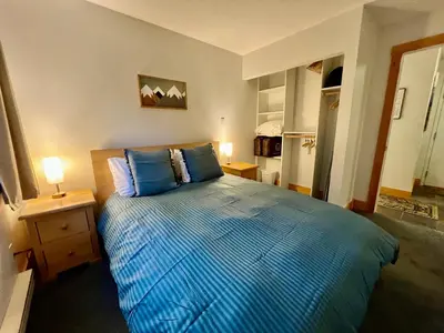 a bedroom with a blue bed with two blue pillows at Panorama Mountain Resort - Horsethief Lodge with Fairmont Creek in Panorama