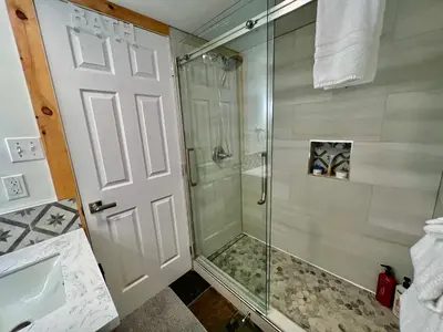 a shower with a glass door in a bathroom at Panorama Mountain Resort - Horsethief Lodge with Fairmont Creek in Panorama