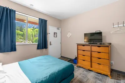 a bedroom with a bed and a tv on a dresser at Squamish Adventure Inn in Squamish