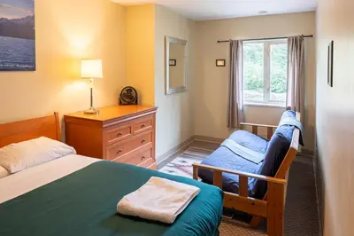 a bedroom with two beds and a window at Squamish Adventure Inn in Squamish