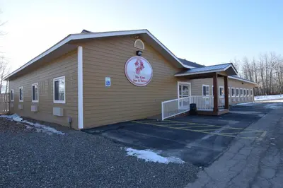 a building with a sign on the side of it at The Lion Inn & Suites in Chetwynd