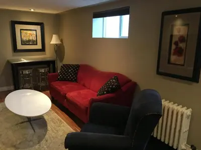 a living room with a red couch and a table at The White Brick Inn in Jasper