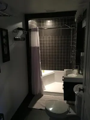 a bathroom with a shower and a toilet and a sink at The White Brick Inn in Jasper