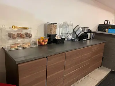 a kitchen counter with donuts and other items on it at Westport Inn in Grande Prairie
