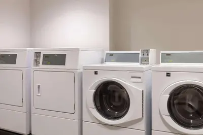 four washing machines and a washer and dryer in a room at Microtel Inn & Suites by Wyndham Bonnyville in Bonnyville