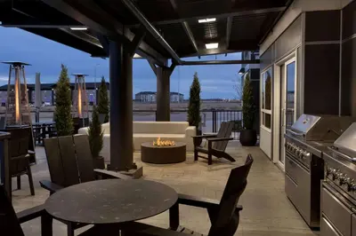 a patio with a couch and a fire pit at Microtel Inn & Suites by Wyndham Bonnyville in Bonnyville