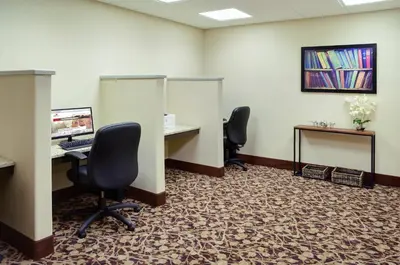 an office with two desks and two chairs and a computer at Pomeroy Inn and Suites Vermilion in Vermilion