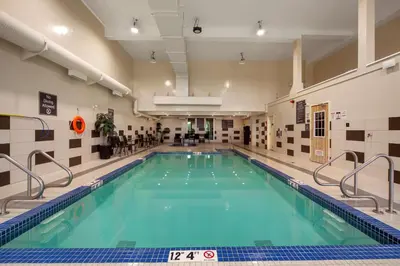 a swimming pool with blue water in a building at Best Western PLUS Fort Saskatchewan Inn & Suites in Fort Saskatchewan