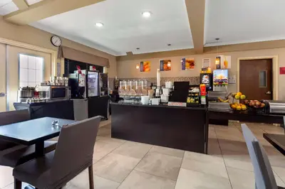 a coffee shop with a counter and a restaurant at Best Western PLUS Fort Saskatchewan Inn & Suites in Fort Saskatchewan