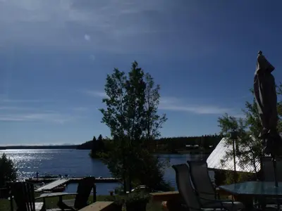 a view of a lake with a table and chairs at Nimpo Lake Resort in Nimpo Lake