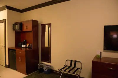 a room with a mirror and a chair in it at Chateau Nova Peace River in Peace River