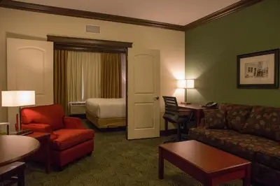 a hotel room with a couch and a bed at Chateau Nova Peace River in Peace River