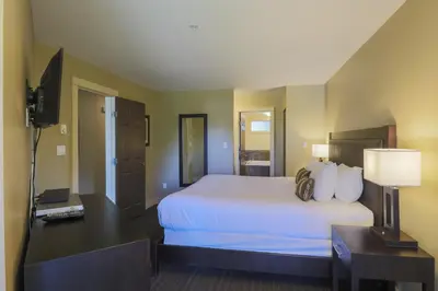 a hotel room with a large white bed and a desk at Pacific Shores Resort & Spa in Nanoose Bay