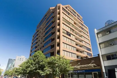 a tall building in the middle of a city at Howe Street Apartment with Views in Vancouver