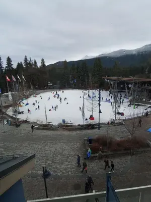 a group of people playing in a ski slope at Tyndalstone Lodge 3 Bedroom in the Heart of Village North Whistler in Whistler