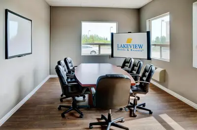 a conference room with a table and chairs at Lakeview Inns & Suites - Fort Saskatchewan in Fort Saskatchewan