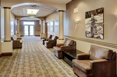 a waiting room with couches and chairs in a building at Lakeview Inns & Suites - Fort Saskatchewan in Fort Saskatchewan
