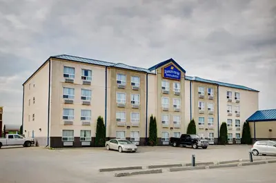 a large building with cars parked in a parking lot at Lakeview Inns & Suites - Fort Saskatchewan in Fort Saskatchewan