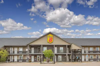a building with a sign on the top of it at Super 8 by Wyndham Fort McMurray in Fort McMurray