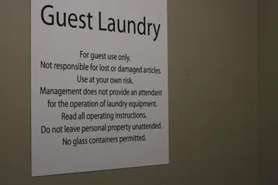 a sign that says guest laundry on a wall at Holiday Inn Express & Suites Terrace by IHG in Terrace