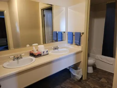 a bathroom with two sinks and a toilet at Dockside Inn in Cold Lake