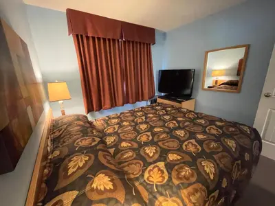 a hotel room with a bed and a television at Dockside Inn in Cold Lake