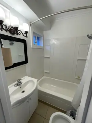 a bathroom with a sink and a toilet and a tub at Sunset Motel in Cache Creek