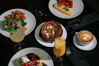 a table topped with plates of food and drinks at The Westin Wall Centre, Vancouver Airport in Richmond