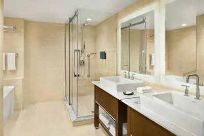 a bathroom with two sinks and a shower at The Westin Wall Centre, Vancouver Airport in Richmond