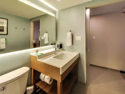 a bathroom with a sink and a toilet and a mirror at Hyatt Place Edmonton West in Edmonton