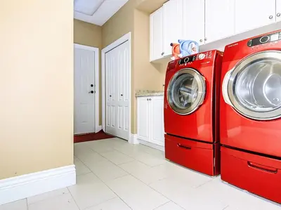a red washer and dryer in a kitchen at Vancouver Luxury Homestay in Richmond