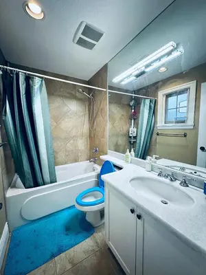 a bathroom with a toilet and a sink and a tub at Vancouver Luxury Homestay in Richmond