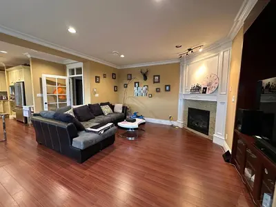 a living room with a couch and a fireplace at Vancouver Luxury Homestay in Richmond