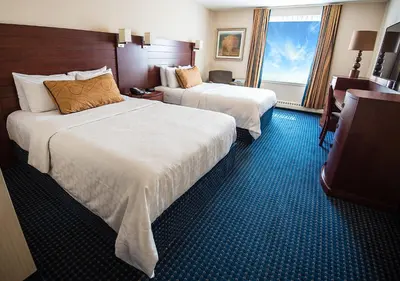 a hotel room with two beds and a window at West Edmonton Mall Inn in Edmonton