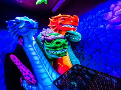 two colorful dinosaur statues sitting next to each other at West Edmonton Mall Inn in Edmonton