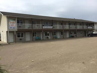 an empty parking lot in front of a building at Kacee's Northern Suites in Fort Nelson