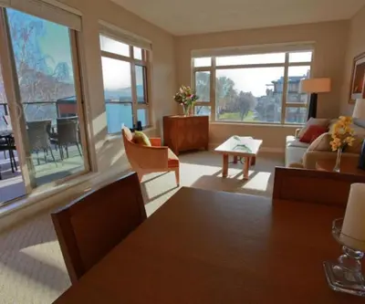 a living room with a couch and a table at Watermark Beach Resort in Osoyoos