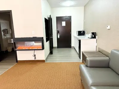 a living room with a fish tank in a hotel room at Southfort Inn in Fort Saskatchewan