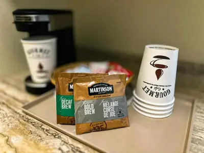 a tray with a bag of bread and a cup of coffee at Hotel Carmacks in Carmacks