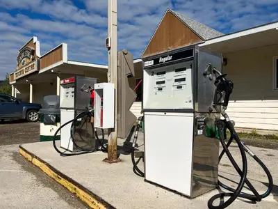 a gas pump in front of a gas station at Hotel Carmacks in Carmacks