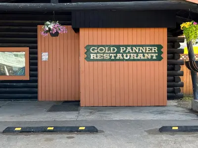 a building with a sign that reads cold painter restaurant at Hotel Carmacks in Carmacks