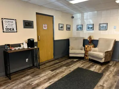 a waiting room with two chairs and a door at Hotel Carmacks in Carmacks