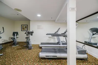 a gym with treadmills and elliptical machines at Best Western Peace Arch Inn in Surrey