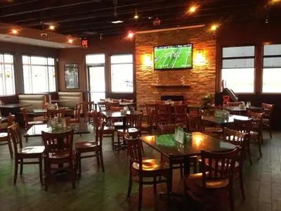 a dining room with tables and chairs and a tv at Western Valley Inn in Valleyview