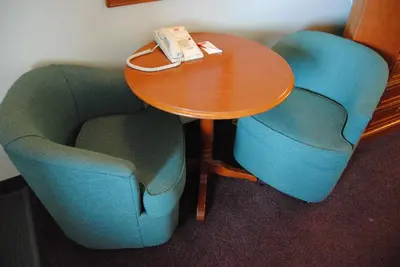 two chairs and a table with a phone on it at Economy Inn in Edmonton