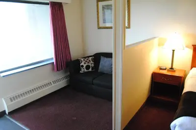 a small room with a couch and a window at Economy Inn in Edmonton